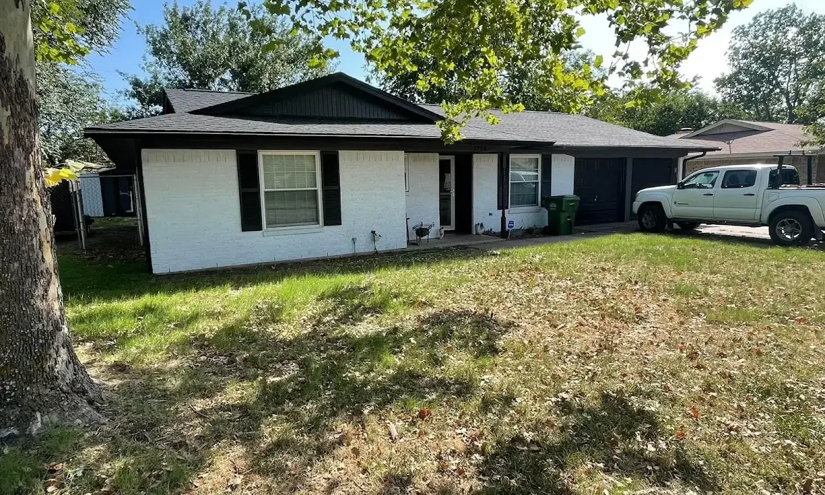 Professional roofing crew working on a residential roof in Guilford